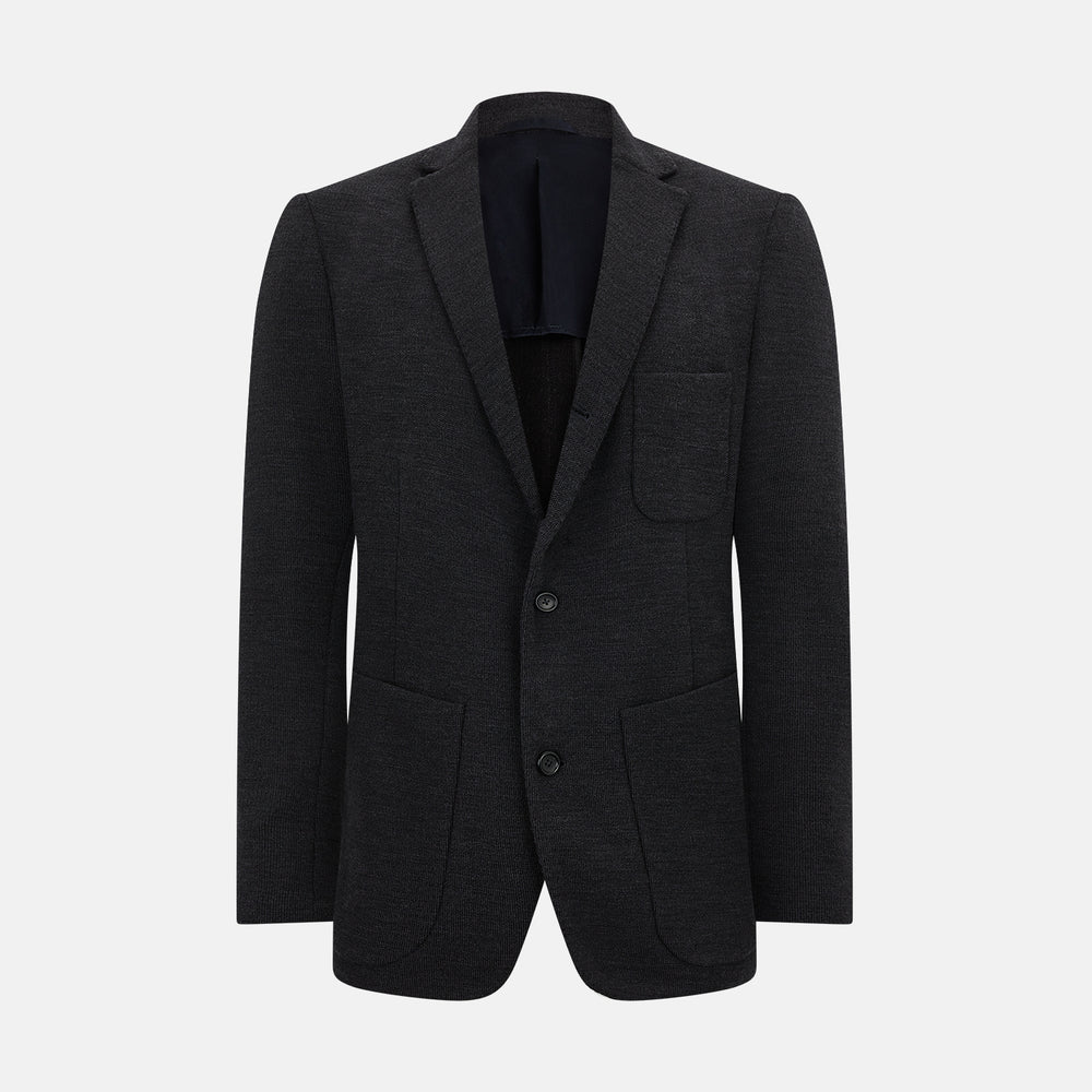 The Turnbull & Asser Charcoal Knitted Oxford Blazer features a notched lapel, two-button closure, and three front pockets, blending modern elegance with British heritage against a plain white background.