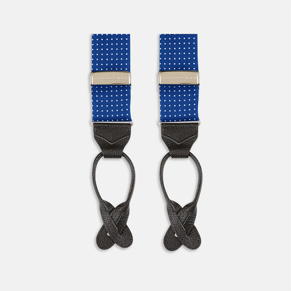 Turnbull & Asser Royal Blue Small Spot Adjustable Silk Braces, detailed with black leather ends and silver clips, are perfect for refined style. Shown laid flat on a plain white background.