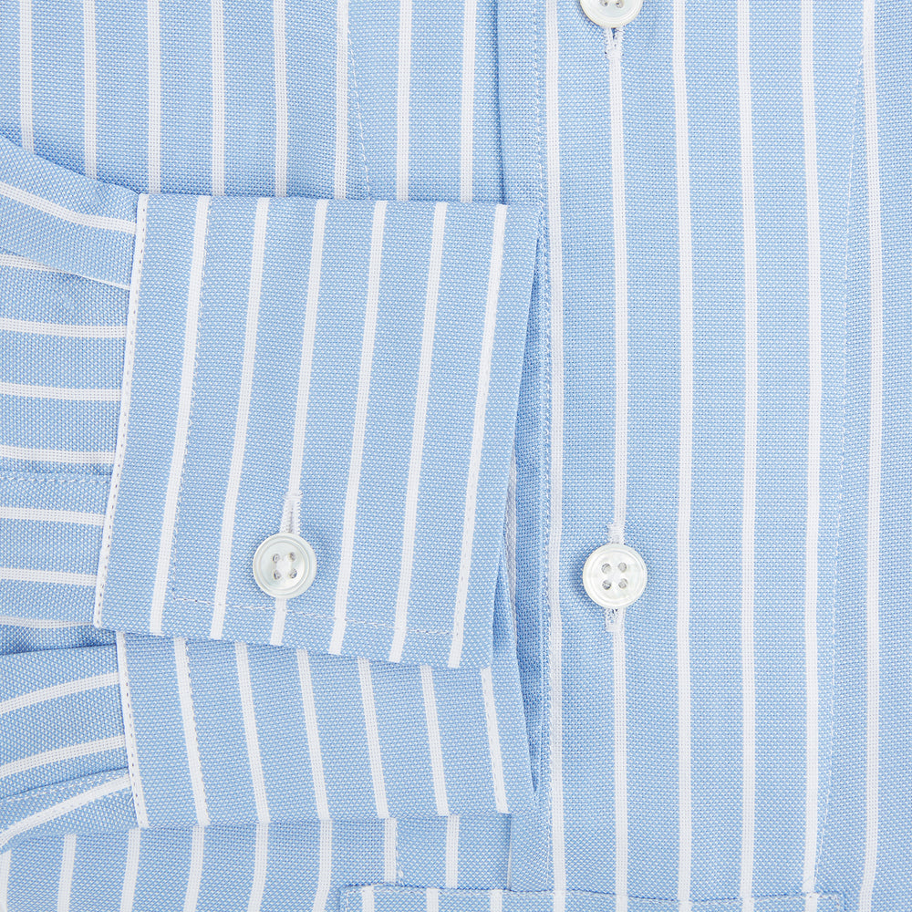 The Turnbull & Asser White and Blue Stripe Quarzo Nightshirt features long sleeves, a collar, button-up front, chest pocket, and mid-length hem—a classic men's striped sleepwear piece.