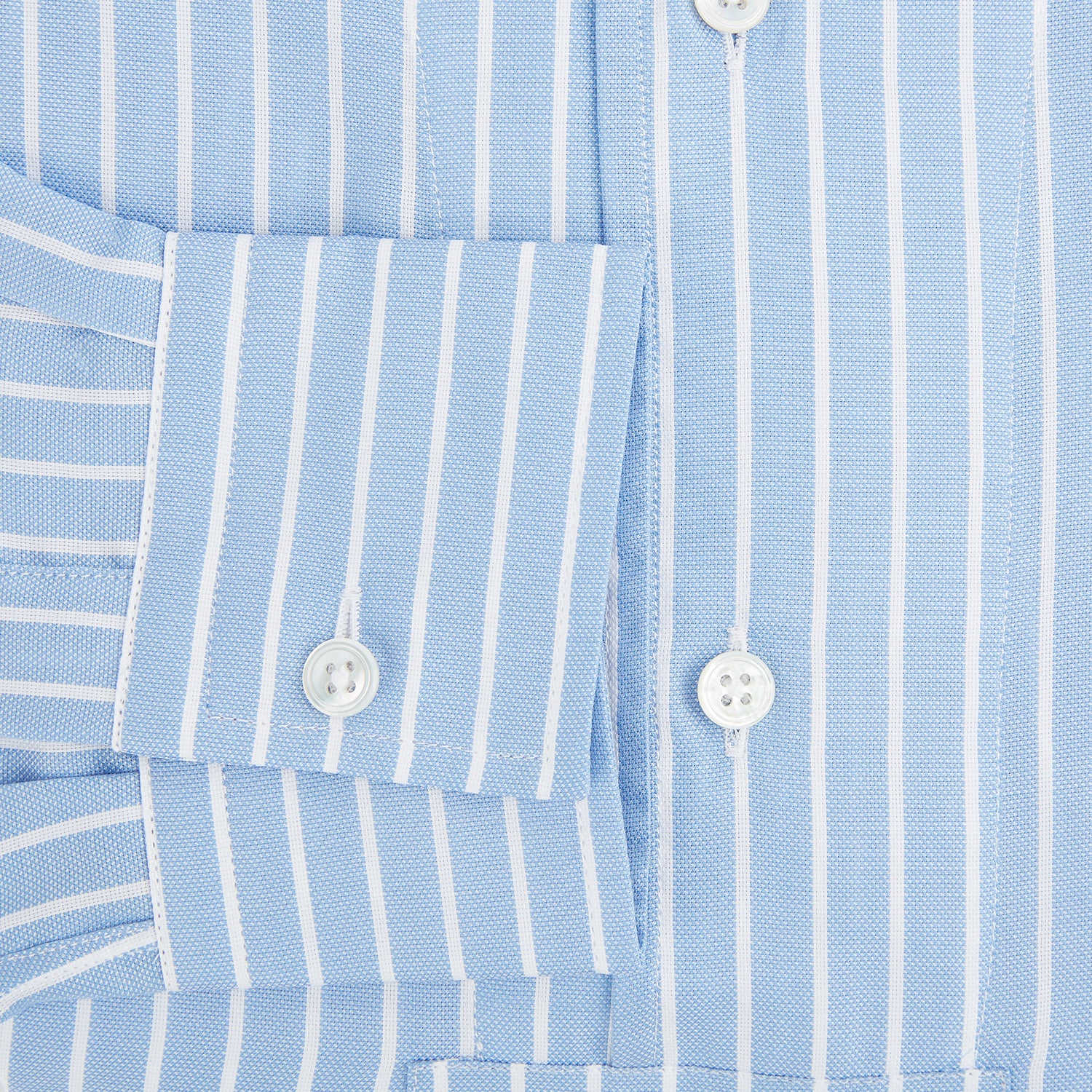 View 4 of product The Turnbull & Asser White and Blue Stripe Quarzo Nightshirt features long sleeves, a collar, button-up front, chest pocket, and mid-length hem—a classic men's striped sleepwear piece.