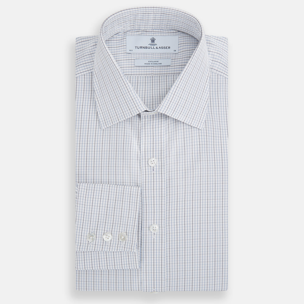 The Turnbull & Asser Pale Blue and Grey Grid Check Mayfair Shirt features long sleeves, a pointed collar, and buttoned cuffs. Crafted from Italian cotton, it displays a subtle grid pattern on a plain white background.