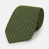 View 1 of product The Turnbull & Asser Green and Blue Micro Dot Silk Tie is shown rolled up, displaying small light blue dots on green silk against a plain white background.