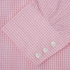 View 6 of product The Turnbull & Asser Light Pink Gingham Check Shirt features a classic T&A collar, 3-button cuffs, and white buttons, neatly folded on a plain white background.