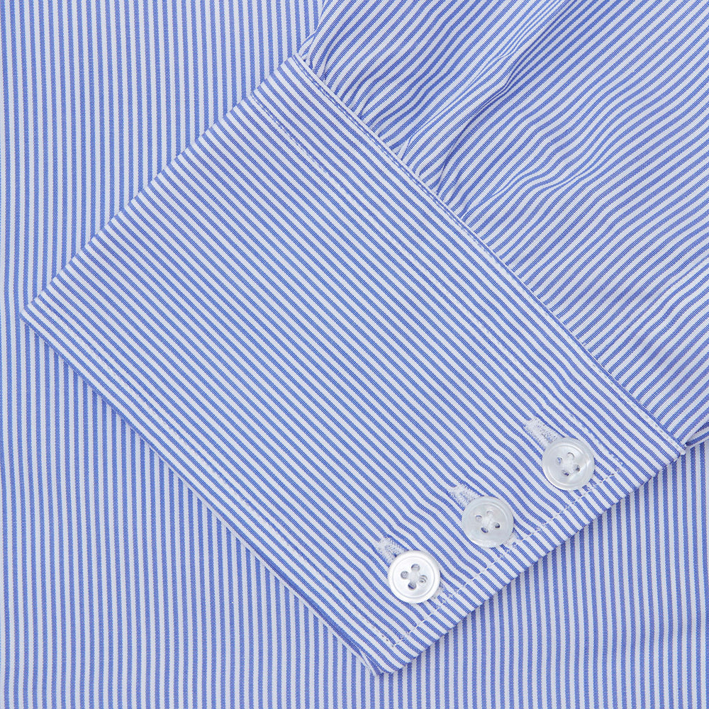 The Turnbull & Asser Blue Fine Bengal Stripe Shirt features a classic T&A collar, 3-button cuffs, and white buttons, crafted from fine cotton and displayed against a crisp white background.