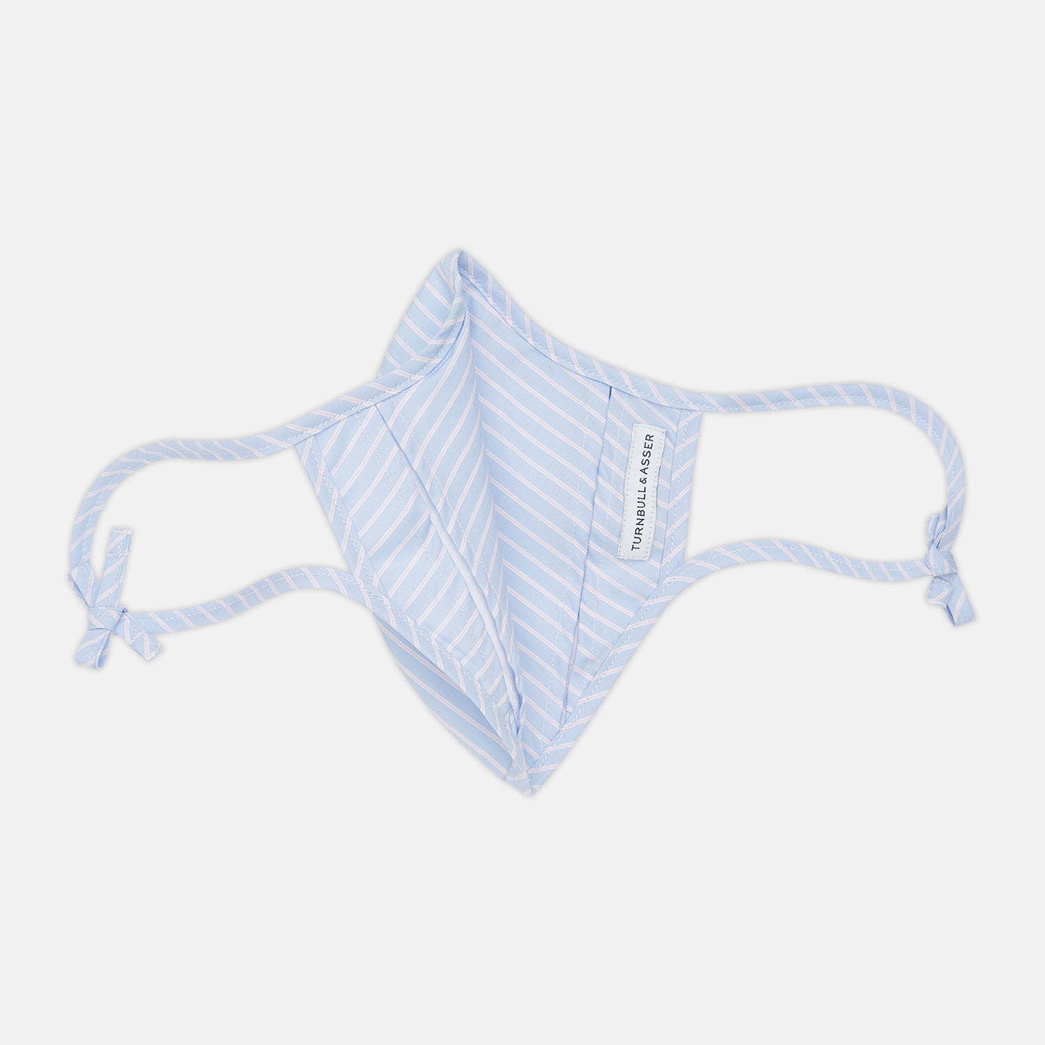 View 5 of product Turnbull & Asser's Exclusive Light Blue, White & Pink Stripe Commuter Mask features ear loops tied in bows and includes 3 VIROFORMULA™ filters for enhanced protection and comfort.