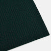 View 2 of product The Turnbull & Asser Forest Green and Charcoal Fretwork Cashmere Knitted Scarf, featuring a subtle geometric pattern, is neatly folded and knotted against a plain white background.