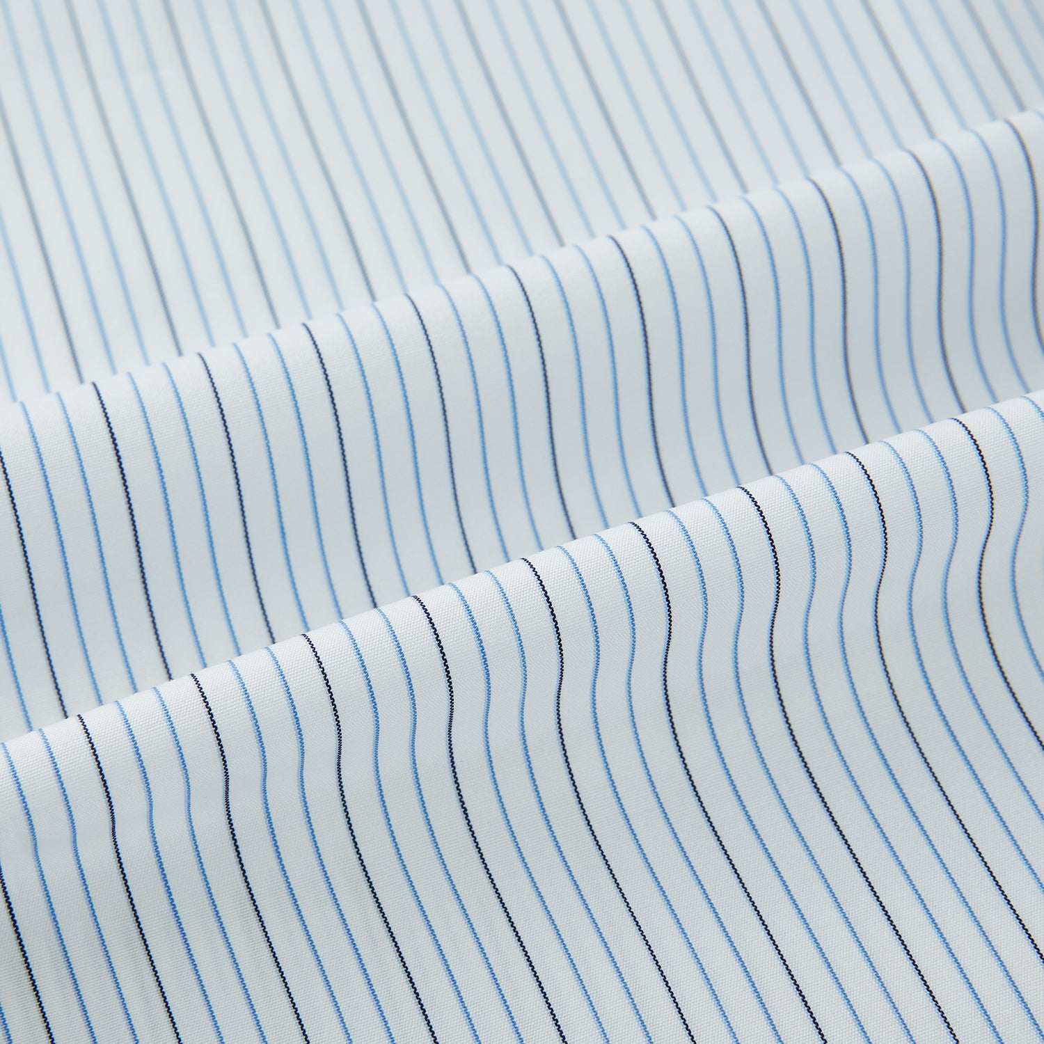 View 8 of product The Turnbull & Asser Pale Blue and Navy Pinstripe Westminster Shirt features long sleeves, a classic collar, and buttoned cuffs, highlighting British craftsmanship. The shirt is laid flat on a white background.