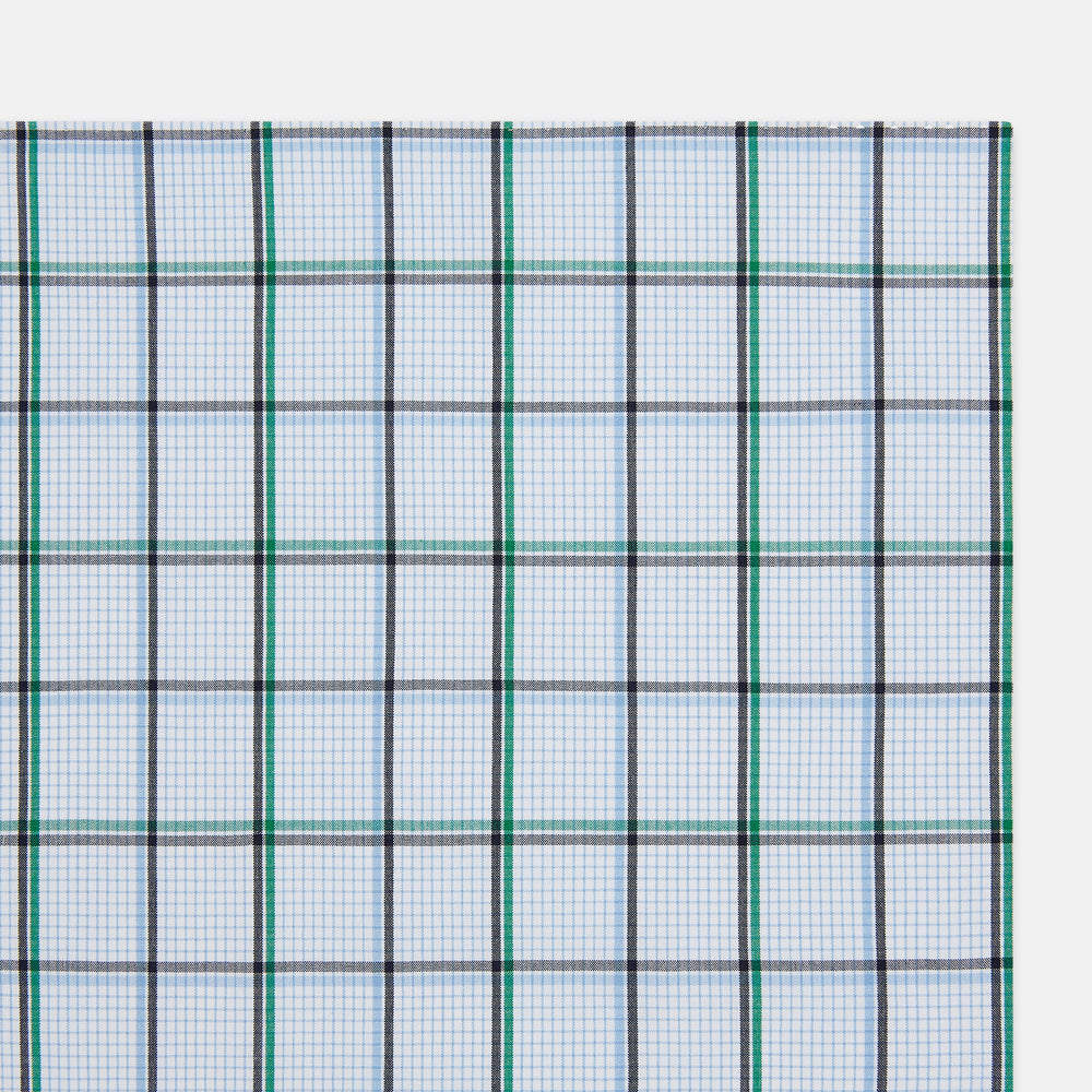 The Turnbull & Asser Hand Rolled Blue and Green Tattersall Check Handkerchief—a white cotton pocket square with blue, green, and black check pattern—is neatly displayed on a plain white background.