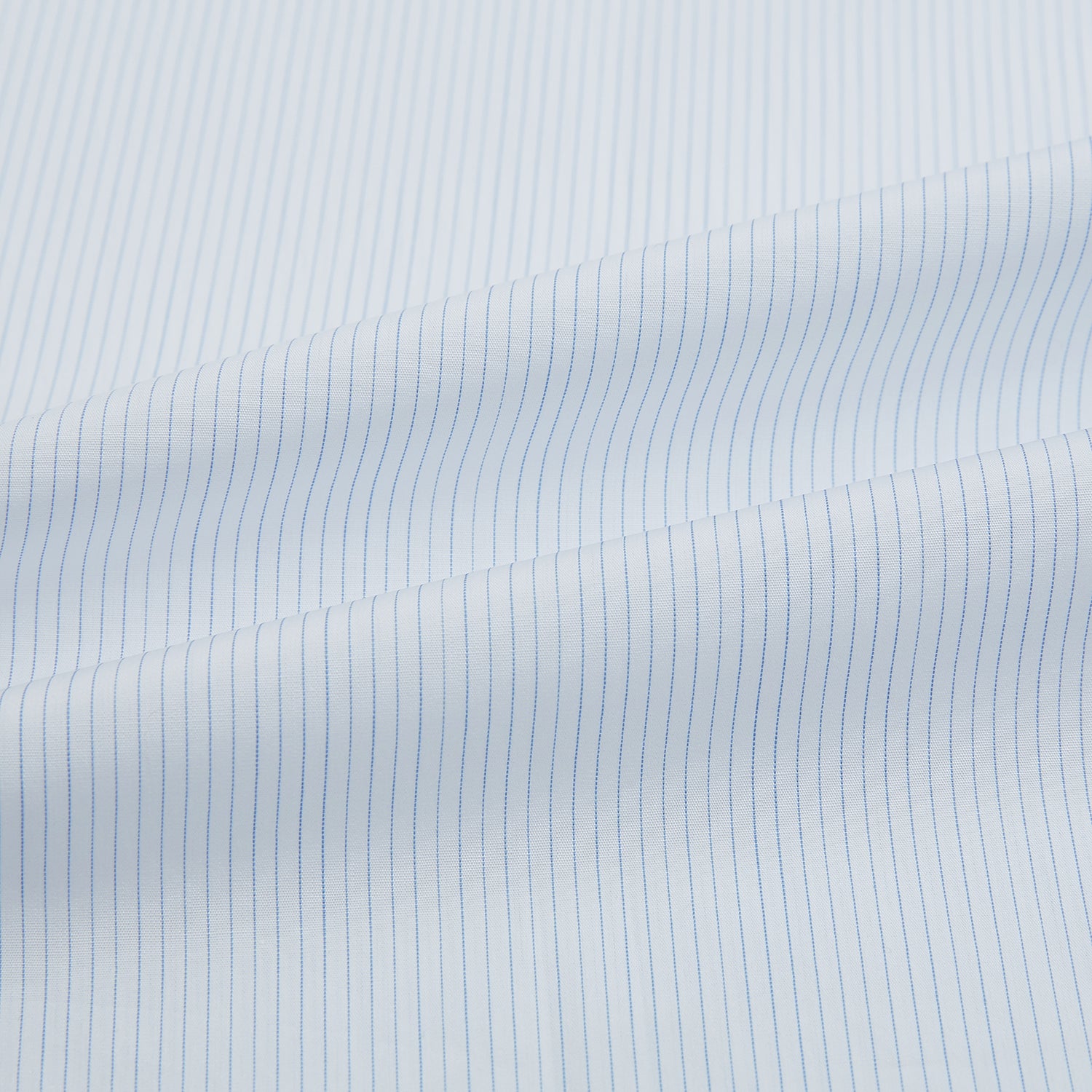 View 6 of product The Turnbull & Asser Blue and White Thin Stripe Shirt features a T&A collar and double cuffs, shown against a plain white background.