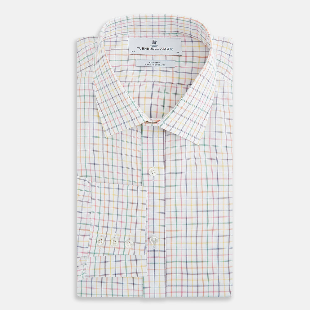 The Rainbow Double Grid Check Mayfair Shirt by Turnbull & Asser features a white base with thin blue, red, and green checks and a T&A collar. It’s displayed neatly laid flat on a white background.