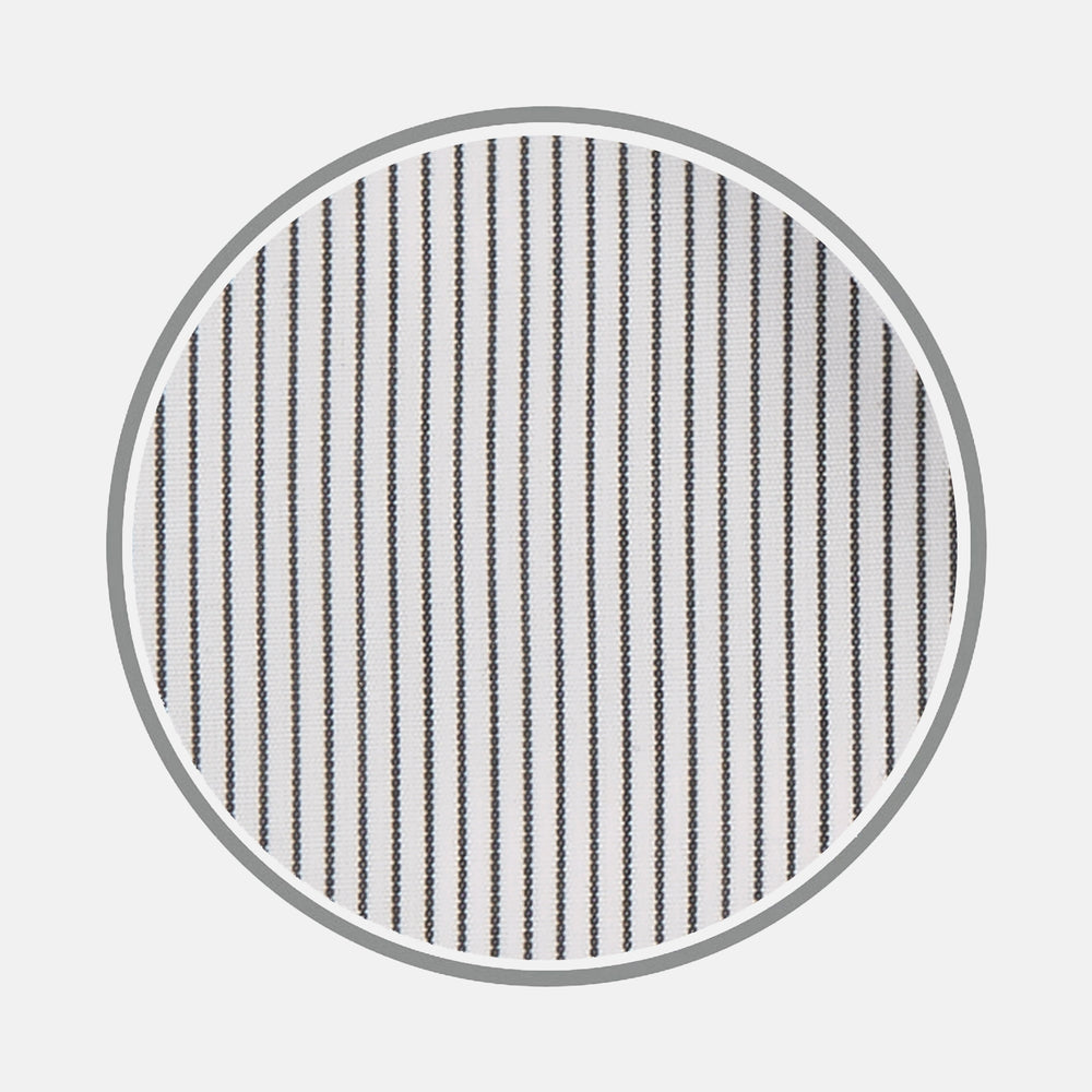 Close-up of Turnbull & Asser's Black Hairline Stripe Cotton Fabric, featuring evenly spaced thin black vertical stripes on white cotton, viewed through a circular frame against a light gray background.