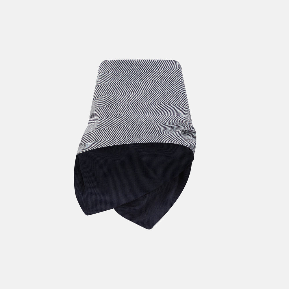 The Turnbull & Asser Navy Herringbone Silk and Linen Neck Warmer features a grey and white pattern, button closure, and dark navy lining—a refined formal accessory for any wardrobe.