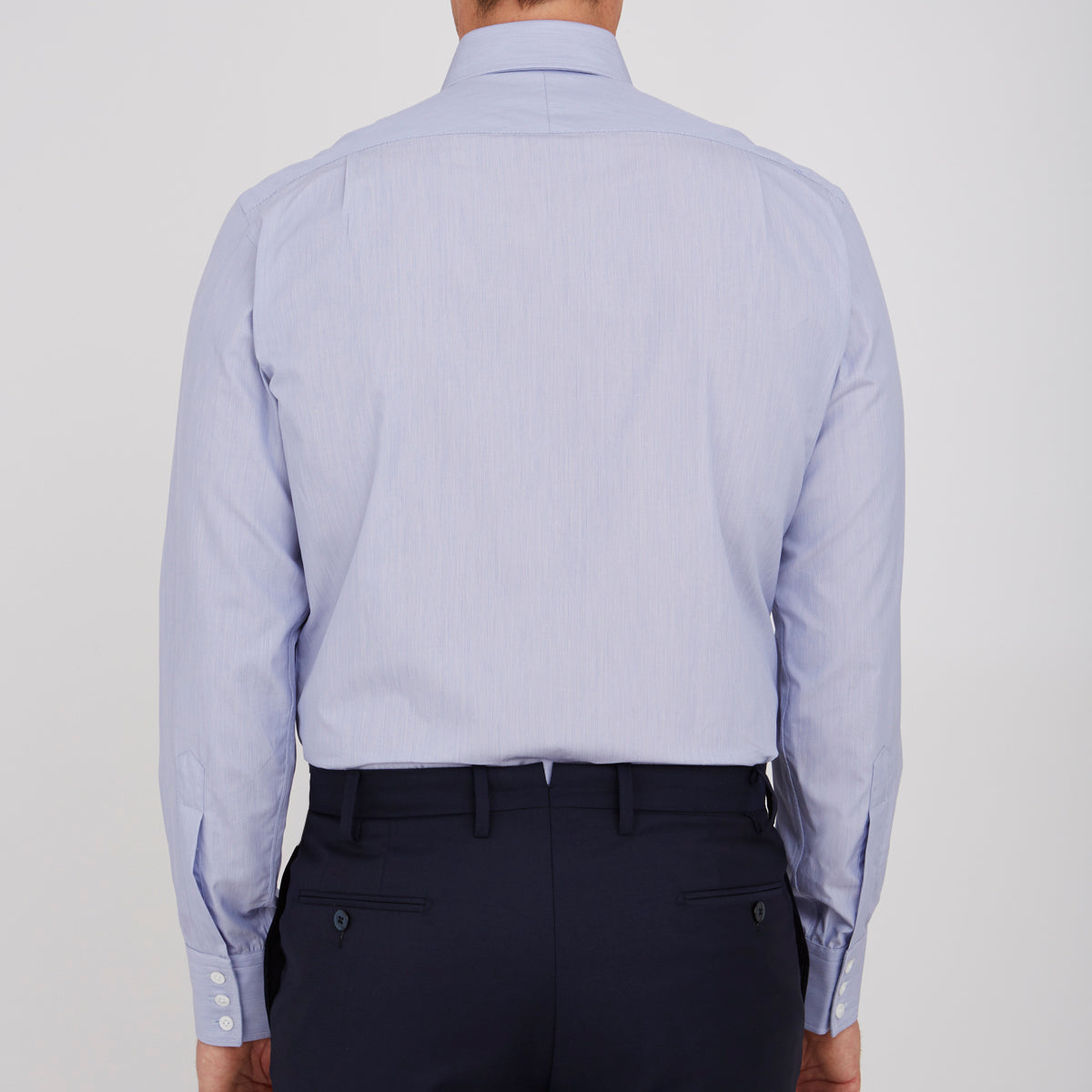 View 3 of product The Turnbull & Asser Blue Hairline Stripe Shirt features a T&A collar, 3-button cuffs, and subtle stripes, displayed neatly folded against a plain white background.