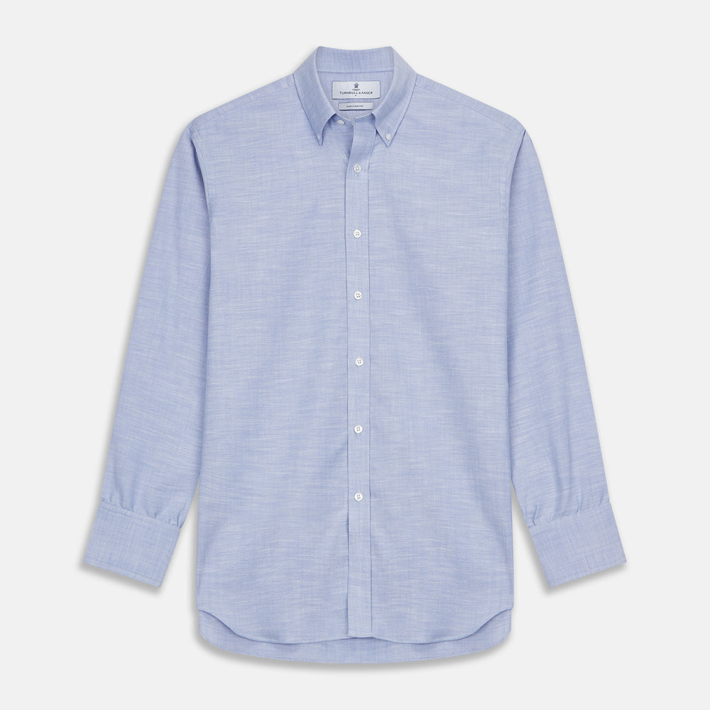 The Turnbull & Asser Mid-Blue Chambray Weekend Fit Shirt features a Dorset collar, white buttons, and 1-button cuffs. It is laid flat on a white background.