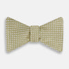 View 1 of product The Turnbull & Asser Gold and White Square Silk Bow Tie features a textured design with square patterns, ideal for formalwear, and is elegantly presented on a white background.