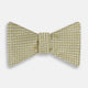 The Turnbull & Asser Gold and White Square Silk Bow Tie features a textured design with square patterns, ideal for formalwear, and is elegantly presented on a white background.