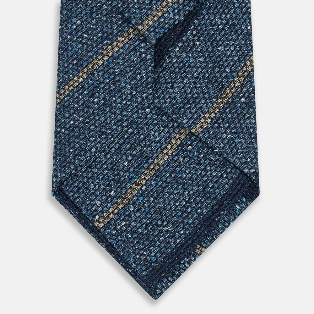 The Blue Multi Stripe Silk Tie by Turnbull & Asser, featuring navy and cream stripes on blue English silk, is shown rolled up against a white background.