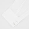 View 2 of product A Turnbull & Asser Tailored Fit Two-Fold 120 White Cotton Shirt with a Kent collar and 2-button cuffs is neatly folded against a light blue background, displaying the brand label inside the collar.
