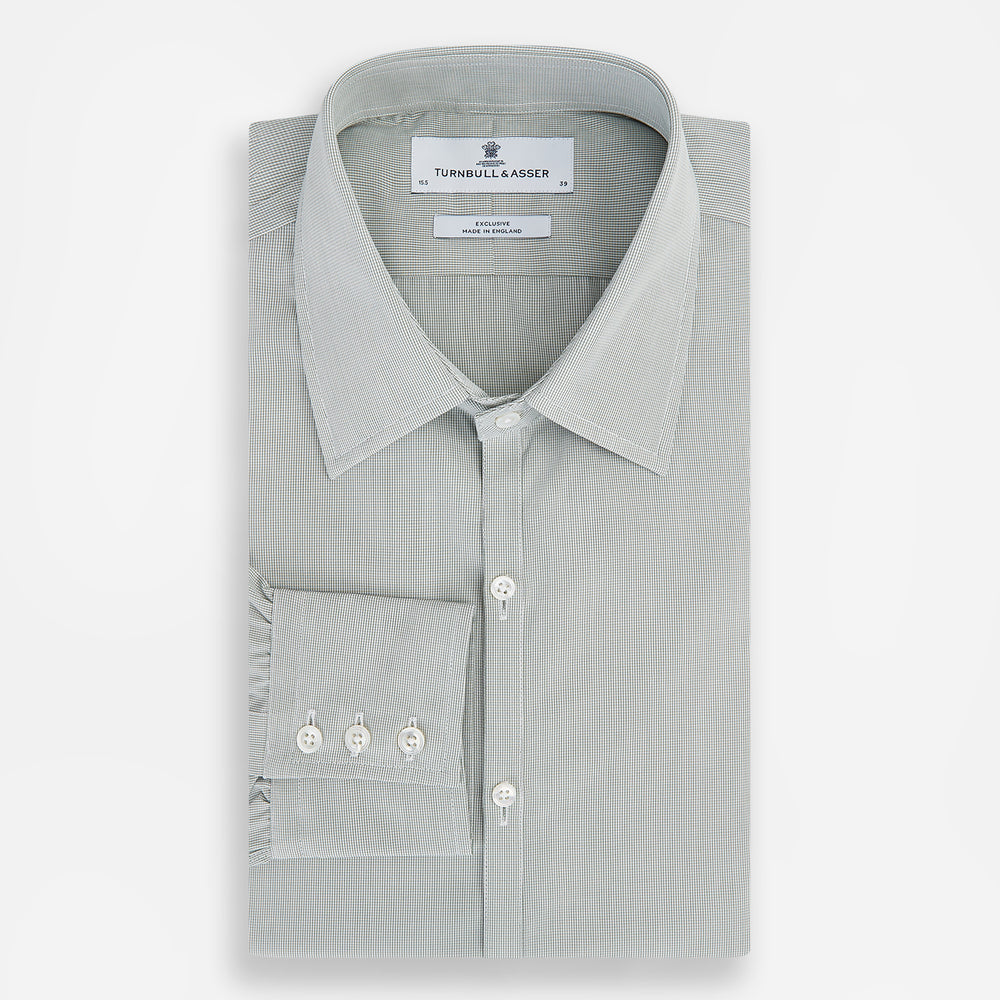 A dark green micro graph check Westminster shirt by Turnbull & Asser, featuring fine British craftsmanship, a Turnbull collar, and white buttons, is laid flat on a white background.