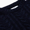 View 2 of product The Turnbull & Asser Navy Wool and Cotton Blend Albany Guernsey Jumper, shown flat on a white background, features long sleeves, a classic cable knit pattern on the upper half, and ribbed cuffs, hem, and collar.
