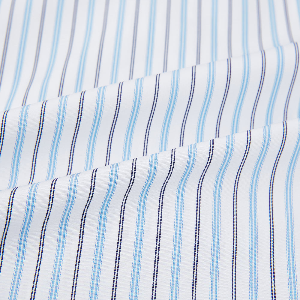 The Turnbull & Asser Blue Multi Halo Stripe Mayfair Shirt features long sleeves, a T&A collar with pointed tips, and buttoned cuffs, shown on a plain white background.