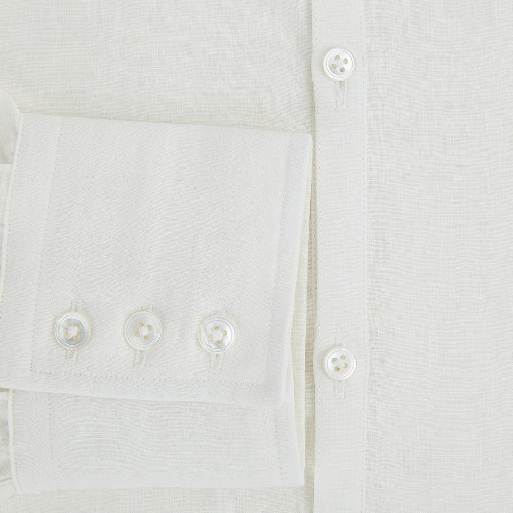 The Vanilla Linen Westminster Shirt by Turnbull & Asser is a long-sleeve, white button-up with a Turnbull collar, buttoned cuffs, and straight hem, highlighting British craftsmanship against a plain white background.