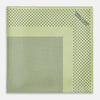 View 3 of product The Melon Green Dot Silk Pocket Square by Turnbull & Asser is handmade in England from silk, featuring small black polka dots. Shown folded with a turned-up corner, it displays both sides of the light green fabric.