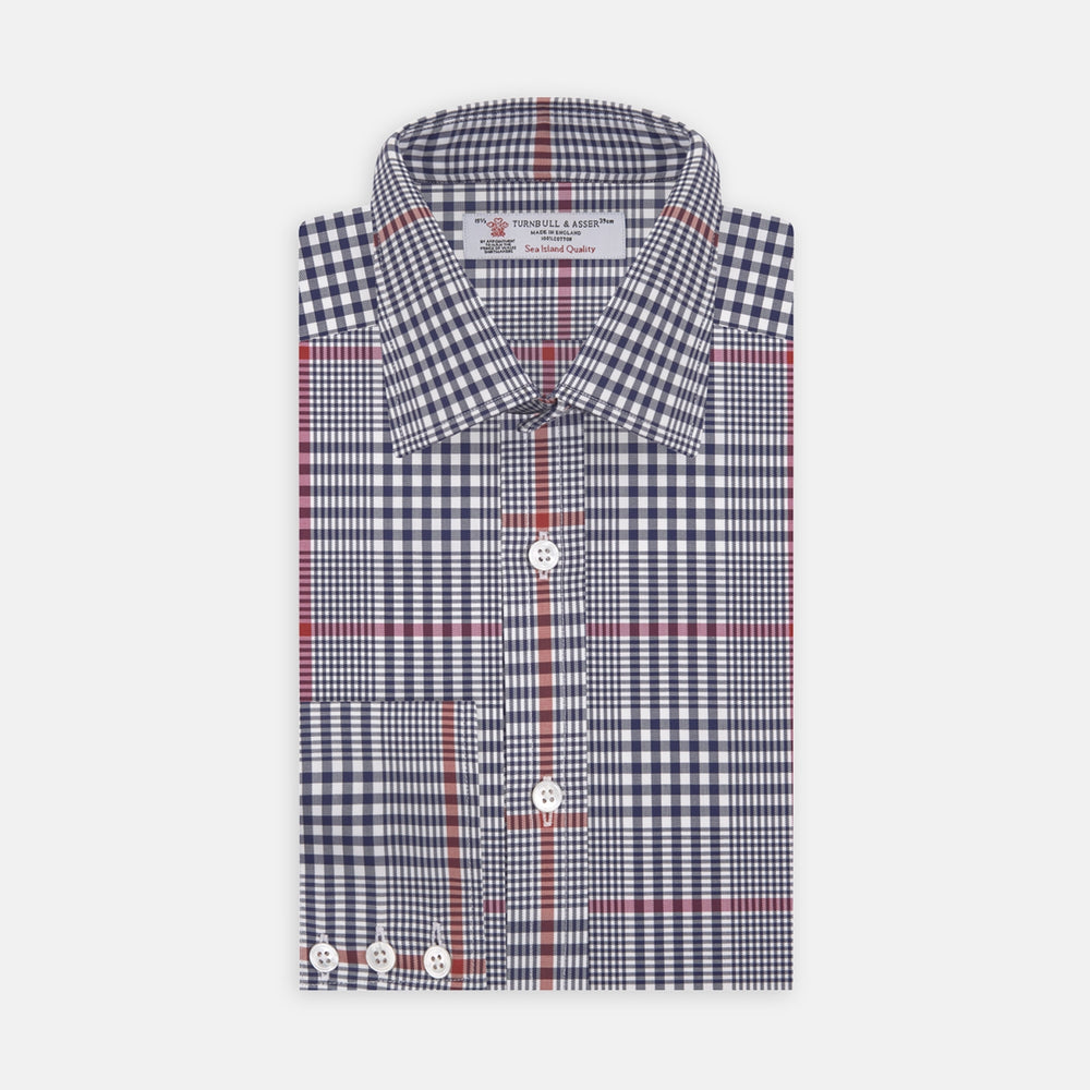 A circular swatch of Turnbull & Asser’s Navy and Red Prince of Wales Wide Check Cotton Fabric displays navy, white, and red intersecting stripes in a traditional check pattern, outlined by a gray border.