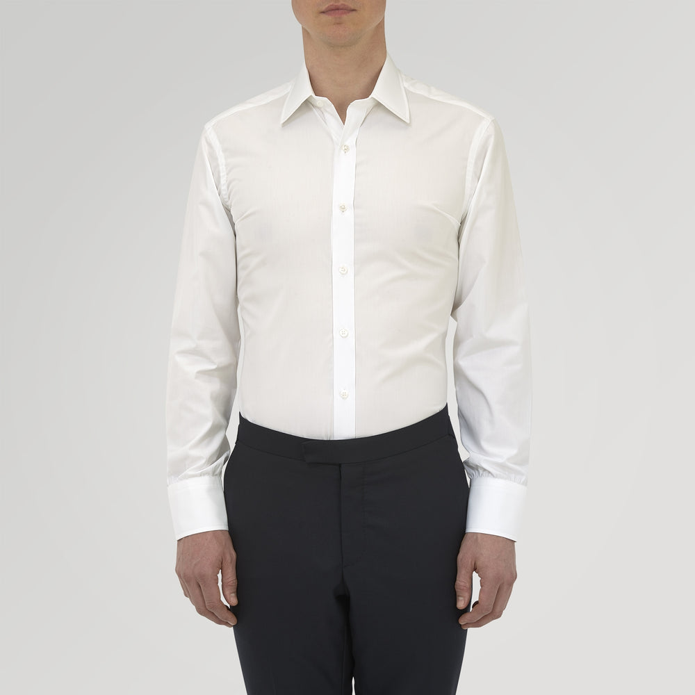 The Turnbull & Asser Tailored Fit Two-Fold 120 White Cotton Shirt features a Kent collar, double cuffs, and button-down front, displayed neatly folded against a light blue background.