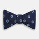 The Navy and Sky Blue Motif Silk Bow Tie by Turnbull & Asser features a subtle ribbed texture and light blue and white geometric floral patterns—an elegant choice for formalwear.