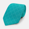 View 1 of product The Turnbull & Asser Turquoise Dotted Check Pattern Printed Silk Tie is shown rolled up on a plain white background.