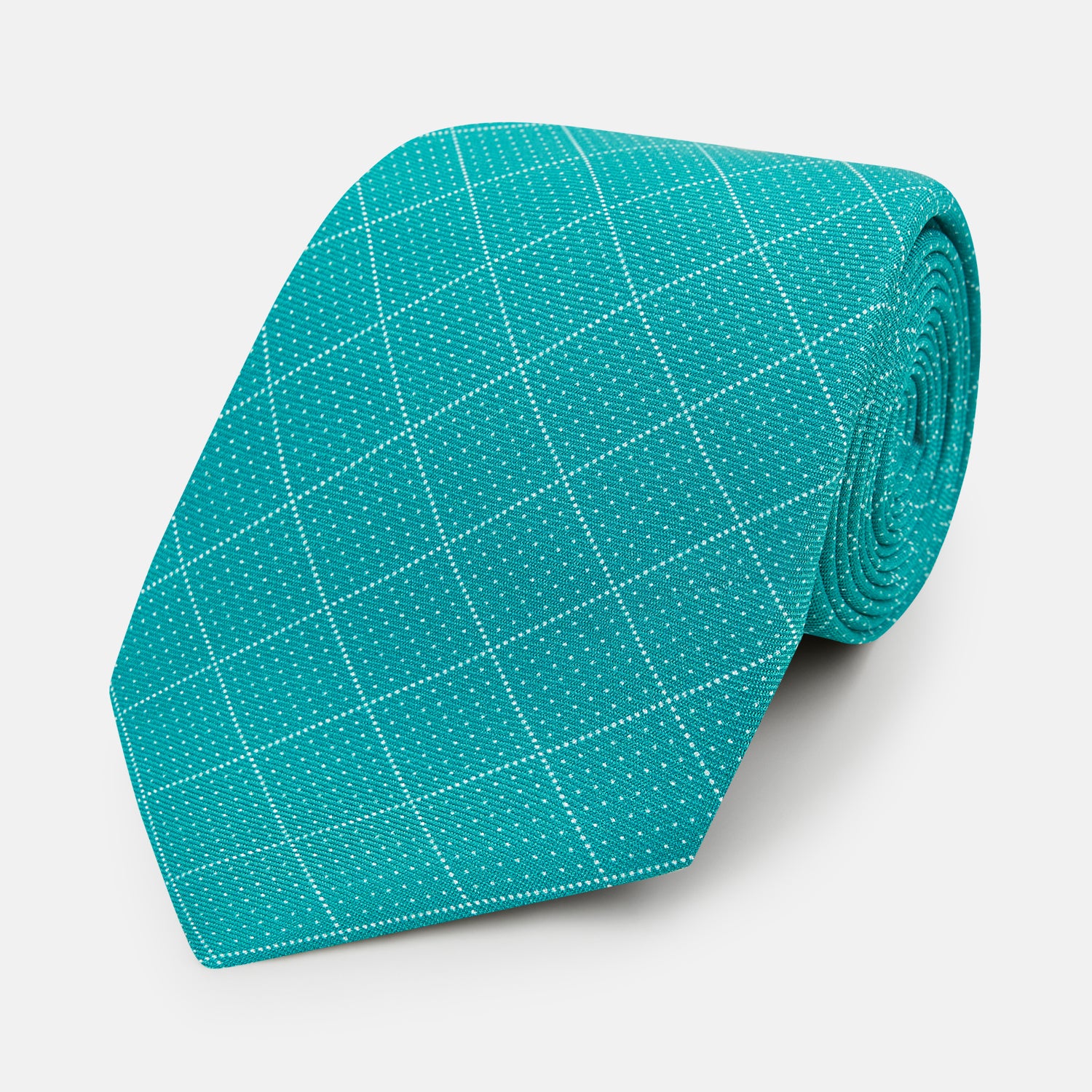View 1 of product The Turnbull & Asser Turquoise Dotted Check Pattern Printed Silk Tie is shown rolled up on a plain white background.