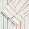 View 3 of product The Burgundy Multi Striped Cotton Sussex Nightshirt by Turnbull & Asser features long sleeves, knee length, a pointed collar, chest pocket, burgundy and beige stripes on white, buttoned cuffs, and a curved hem for classic sleepwear style.