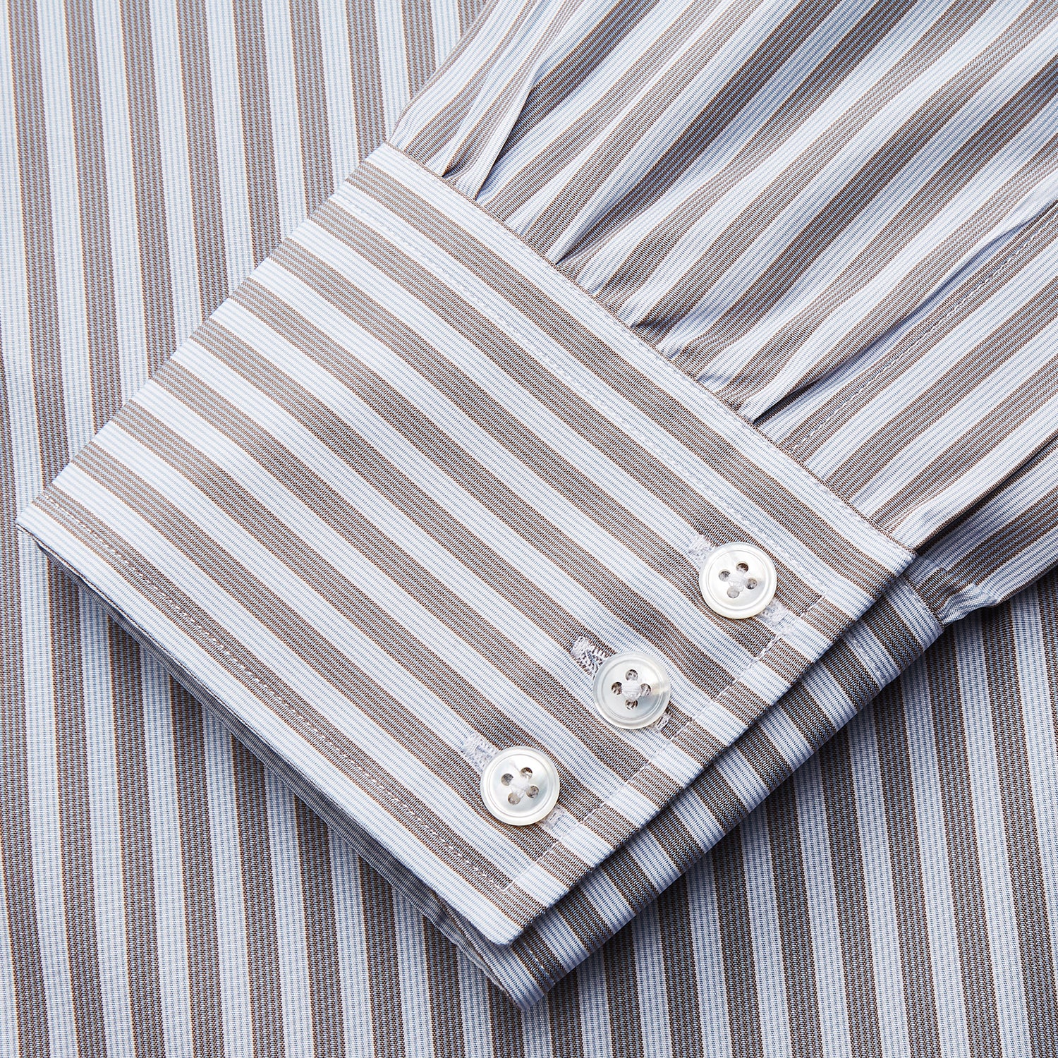View 3 of product The Turnbull & Asser Pale Blue Multi Stripe Cotton Regular Fit Mayfair Shirt features long sleeves, a pointed collar, buttoned cuffs, and vertical stripes in pale blue tones, displayed against a white background.