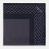 View 4 of product The Turnbull & Asser Navy and Lilac Dot Silk Pocket Square features small white polka dots with a wider border of spaced-out dots, neatly folded to showcase both sides of its handmade silk fabric.