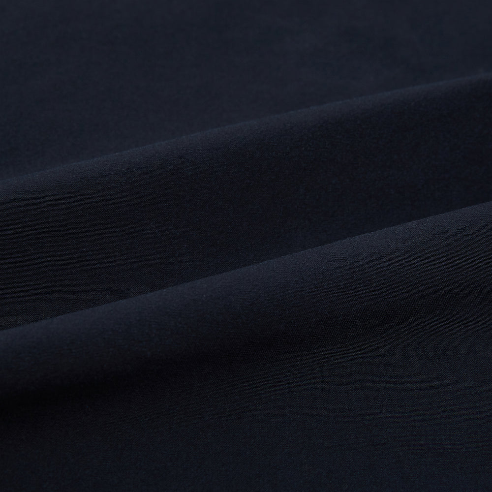 The Midnight Blue Hyde Overshirt by Turnbull & Asser is a plain, long-sleeve shirt in dark navy sanforised cotton with a single chest pocket, spread collar, and black buttons, shown laid flat on a white background.