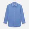 View 1 of product The Turnbull & Asser "The World Is Not Enough" blue cotton Istanbul shirt, as seen on James Bond, is a light blue oxford long-sleeve button-up with a pointed collar and white buttons, displayed on a white background.