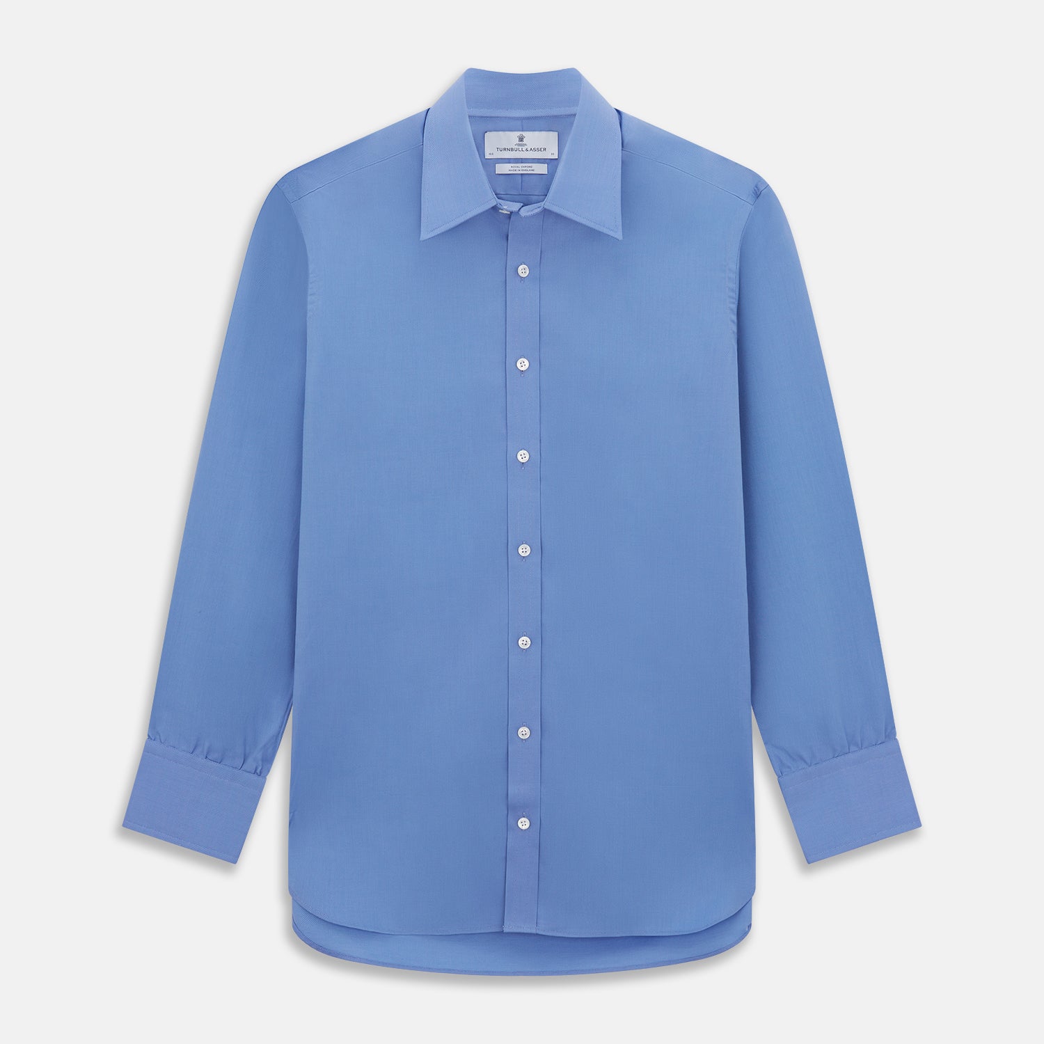 View 1 of product The Turnbull & Asser "The World Is Not Enough" blue cotton Istanbul shirt, as seen on James Bond, is a light blue oxford long-sleeve button-up with a pointed collar and white buttons, displayed on a white background.