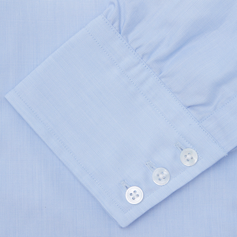 The Turnbull & Asser Light Blue End-on-End Shirt features a T&A collar and 3-button cuffs, neatly displayed against a plain white background—ideal for pairing with a navy suit.
