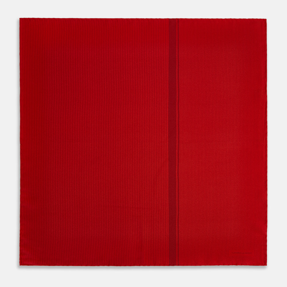 The Red and Burgundy Stripe Silk Pocket Square by Turnbull & Asser features subtle vertical stripes and a darker red stripe along one side, with “Turnbull & Asser” embossed in the fabric and a textured, turned-down corner.