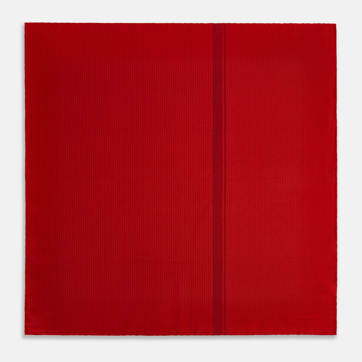 View 4 of product The Red and Burgundy Stripe Silk Pocket Square by Turnbull & Asser features subtle vertical stripes and a darker red stripe along one side, with “Turnbull & Asser” embossed in the fabric and a textured, turned-down corner.