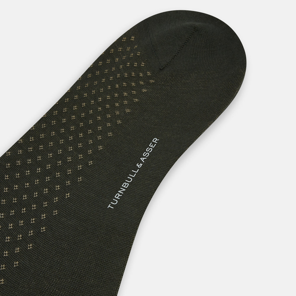 A single Forest Green Motif Long Sock from Turnbull & Asser, crafted from soft mercerised Egyptian cotton, features a subtle pattern, ribbed cuff, and left-foot shaping, displayed on a light background.