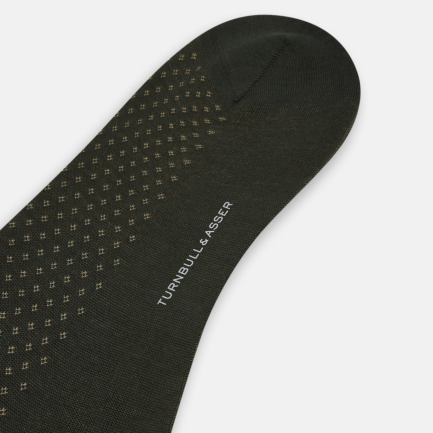 View 3 of product A single Forest Green Motif Long Sock from Turnbull & Asser, crafted from soft mercerised Egyptian cotton, features a subtle pattern, ribbed cuff, and left-foot shaping, displayed on a light background.