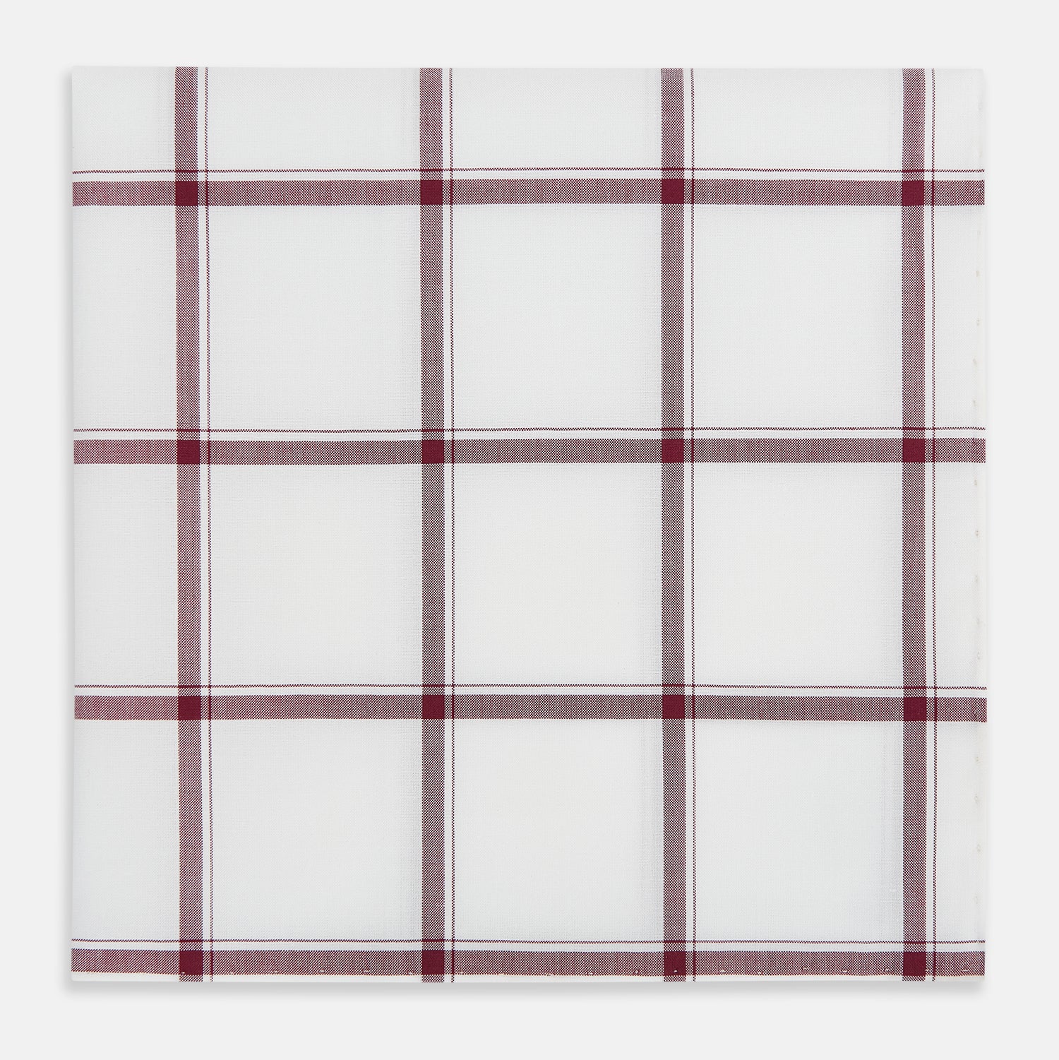 View 1 of product The Turnbull & Asser Burgundy Grid Check Hand-Rolled Handkerchief features a white base with burgundy grid lines forming large squares and is finished with elegant hand-rolled edges.
