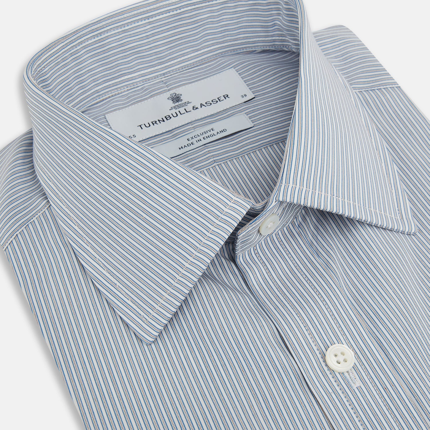 View 2 of product The Blue and Brown Ticking Stripe Mayfair Shirt by Turnbull & Asser, crafted from premium Italian cotton with a collar, white buttons, and buttoned cuffs, is an essential addition to any gentleman's wardrobe.