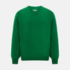 View 1 of product The Turnbull & Asser Grass Green Cashmere V-neck Jumper, with long sleeves, is displayed against a white background, highlighting its classic knitwear style.