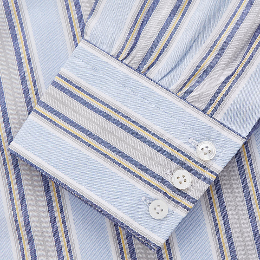 The Turnbull & Asser Pale Blue and Yellow Stripe Cotton Regular Fit Mayfair Shirt is a long-sleeve, button-down formal shirt for men, shown on a plain white background.