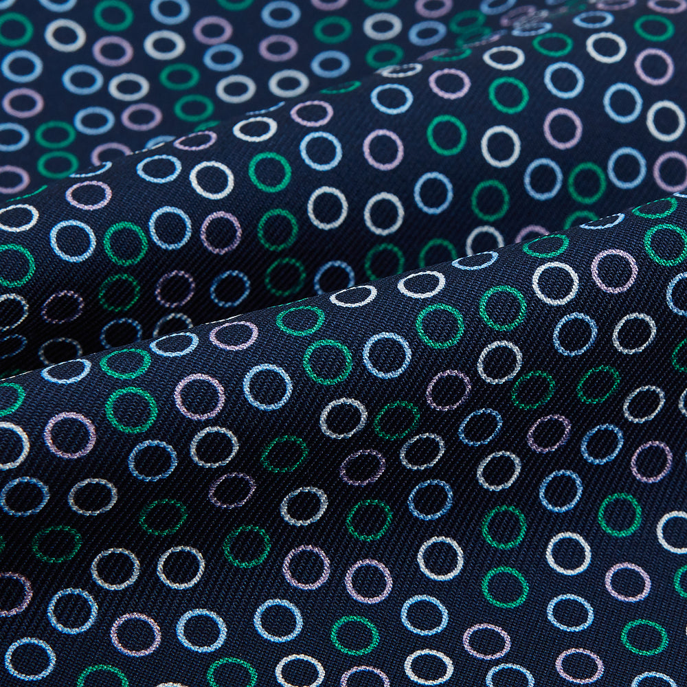 Turnbull & Asser's Multicoloured Dark Navy Circle Silk Cravat features blue, white, and green-outlined circles—ideal for weddings or pairing with classic British attire.