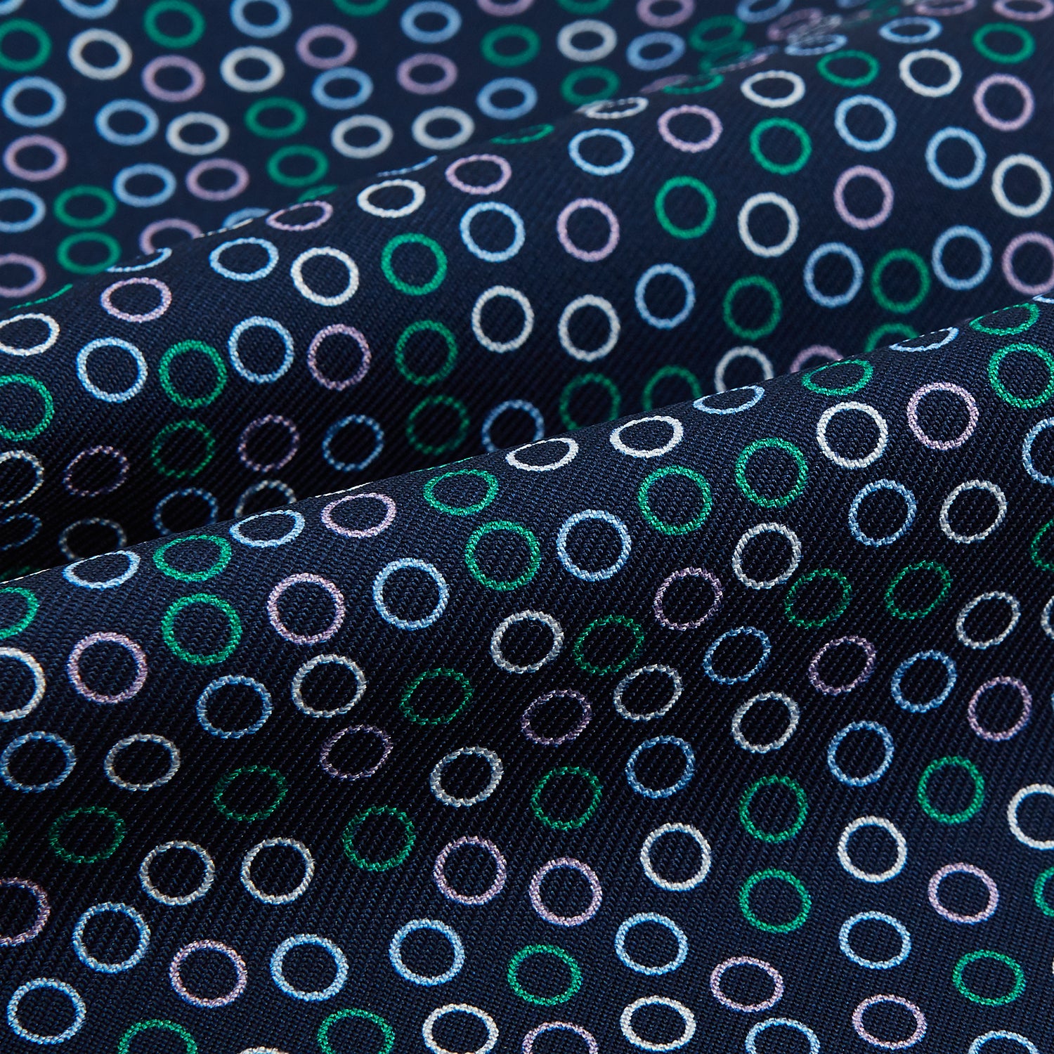 View 4 of product Turnbull & Asser's Multicoloured Dark Navy Circle Silk Cravat features blue, white, and green-outlined circles—ideal for weddings or pairing with classic British attire.