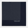 View 4 of product The Navy and White Stripe Silk Pocket Square by Turnbull & Asser features thin white vertical stripes and "TURNBULL & ASSER HAND PRINTED IN ENGLAND" in one corner, with a folded edge showing the reverse of this elegant silk accessory.
